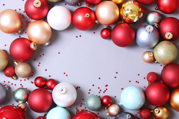 Decorative Christmas balls on a colored background top view. Place to insert text.