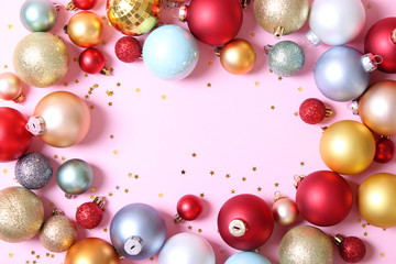 Decorative Christmas balls on a colored background top view. Place to insert text.