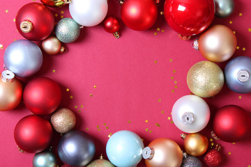 Decorative Christmas balls on a colored background top view. Place to insert text.