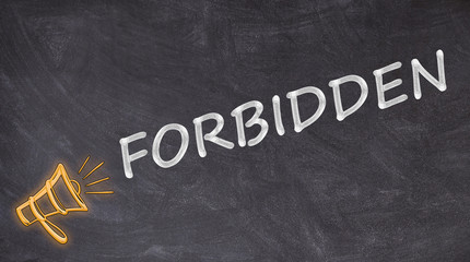 Forbidden written on blackboard with megaphone