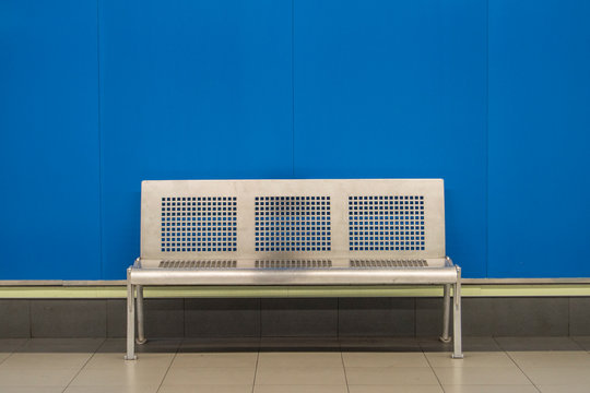 Metallic Bank In A Madrid Subway Station With A Blue Wall Background