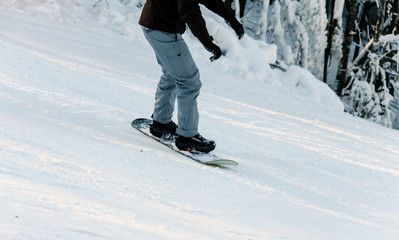 snowboarder descends from a snowy descent