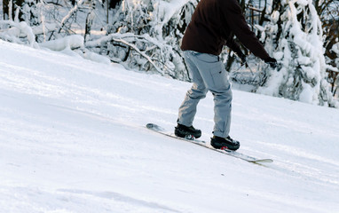 snowboarder descends from a snowy descent