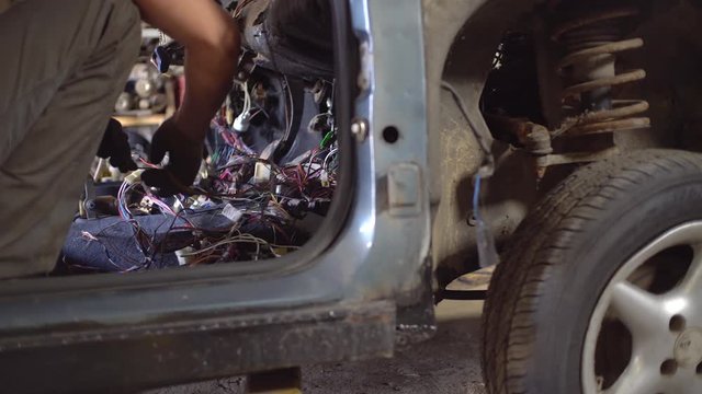 car service master repairs wires, disassembles car. autodismantling.