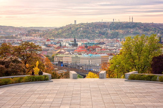 Sunset view of Prague from Vitkov hill with autumn park, scenic sunny cytiscape, Zizkov district, Czech Republic, travel background