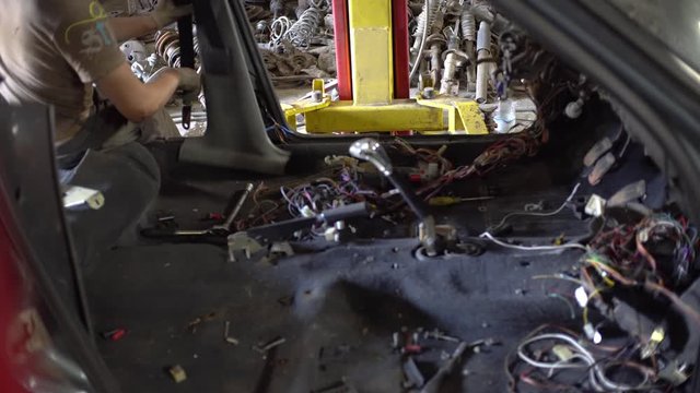 car service master repairs wires, disassembles car. autodismantling.