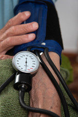measuring the blood pressure at a senior patient
