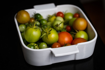 Mix colour tomatoes on black background