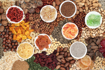 Dried fruit nuts and seed variety forming a background. Health food high in antioxidants, protein, omega 3. minerals, vitamins and anthocyanins. Flat lay.
