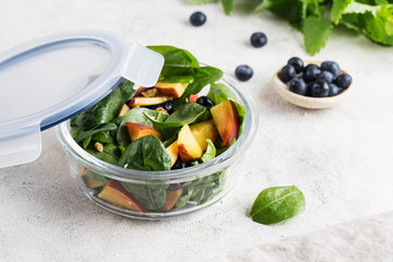 healthy food in a glass container healthy salad food with a white background vegan food salad with spinach peach