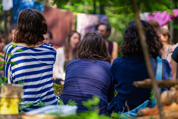 Diverse people enjoy spiritual gathering A large mixture of multicultural people are seen sitting...