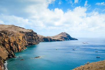 Fototapeta na wymiar Amazing cliffs in Ponta de Sao Lourenco, the easternmost point of Madeira Island, Portugal. Cliffs by the Atlantic ocean. Portuguese volcanic landscape. Travel destination and tourist attraction