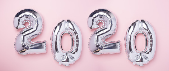 Silver balloons in the form of numbers 2020 on pink background. New year celebration. Air Balloons. Happy New Year concepts. Horizontal banner- Image