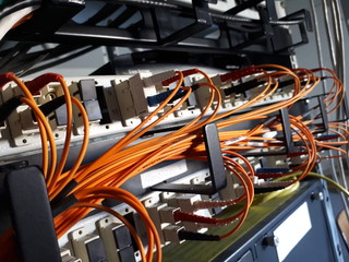 Detail of fiber optics cables on network switches. Data Center.