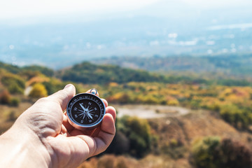 Compass in hand, in the mountains, autumn.