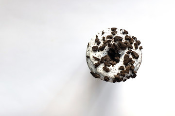 donut with cookie pieces on white background. isolated, copyspace for text