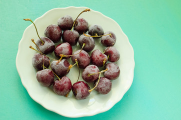 cherry berries cherries frozen by frost on a bright background