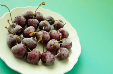 cherry berries cherries frozen by frost on a bright background