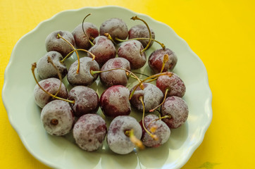 cherry berries cherries frozen by frost on a bright background