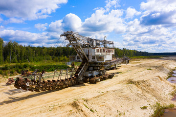 old rusty multi bucket excavator, giant stacker, absetzer in sandy career