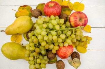 fruits on white. Apples, pears and grapes. Close-up. Beautifully laid out fruits on a  table.