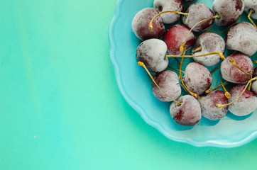 cherry berries cherries frozen by frost on a bright background