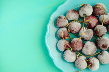 cherry berries cherries frozen by frost on a bright background