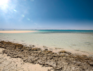 Summer background of sea with beach and blue sunny sky 