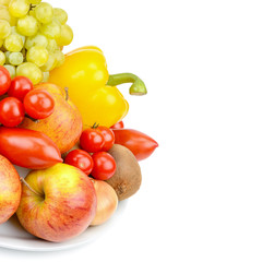 Fruits and vegetables on a platter isolated on white background. Free space for text.