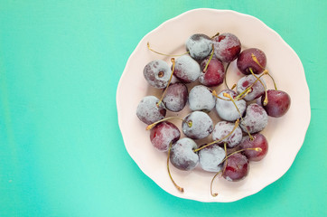 cherry berries cherries frozen by frost on a bright background