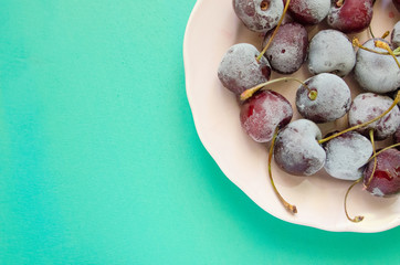 cherry berries cherries frozen by frost on a bright background