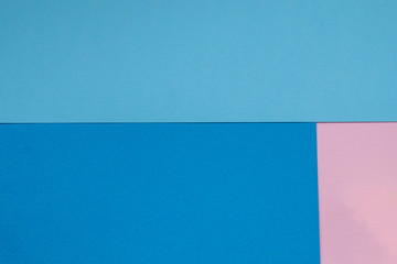 Color papers geometry flat composition background with blue and pink tones