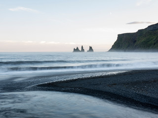 Stacks of basalt columns off the beach of Vik Iceland