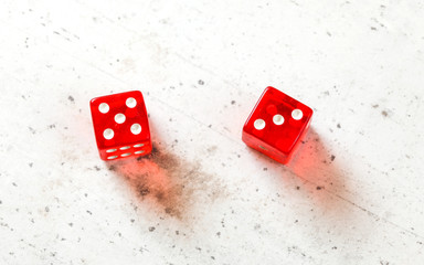 Two red craps dices showing Easy Eight (number 5 and 3) overhead shot on white board