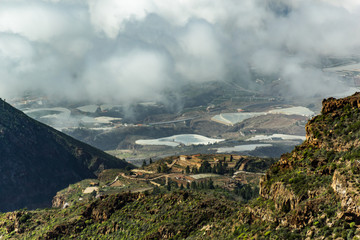 Aerial view of green mountains and southern coast of Tenerife from Macizo de Adeje. Warm sunny day...