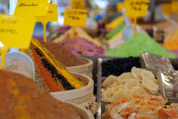 Multi-colored dried fruits and tea in the oriental bazaar.