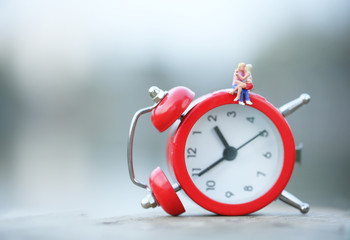 Loving couple cuddles on an alarm clock