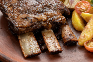 Ethically raised, fresh cut organic rib eye steak grilled with fried potatoes.