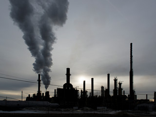 Coal fired power plant spewing steam into the air.