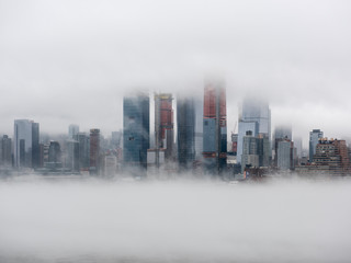 Office and condo highrises emerging through the fog.