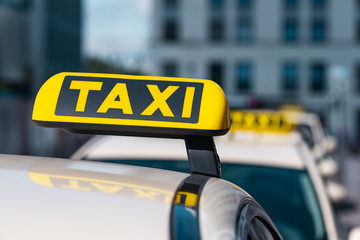 Selected focus at Taxi sign on Taxi service cars