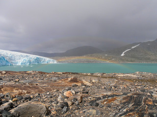 A rainbow over the lake in jostedalsbreen glacier in Norway