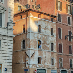 Fototapeta na wymiar Man watching from a balcony in Rome