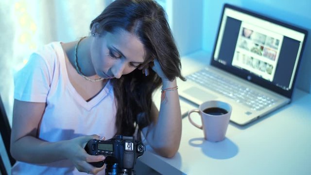 Unhappy woman looks through unsuccessful photos