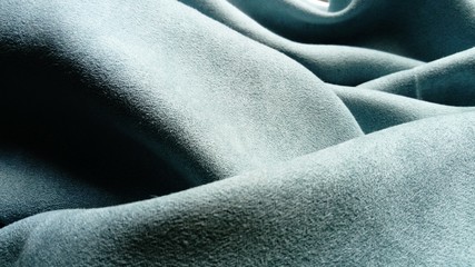The fabric is gray velvet laid by the waves. Close-up. Lighting is natural.