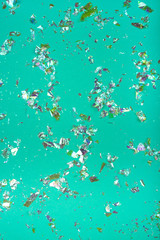 Fototapeta na wymiar Neon confetti on green background. Holiday concept.