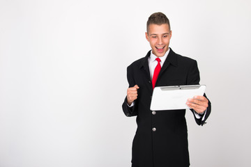 Handsome attractive smiling happy joyful young casual businessman male using tablet isolated on the white background, millennial modern working, gadget online data and information business concept