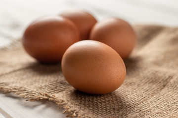 Fresh farm brown eggs over a rustic wood table