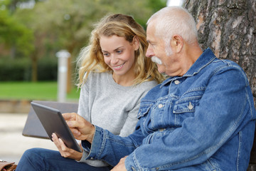 Fototapeta premium woman with laptop and man with book