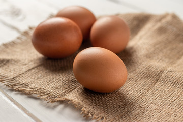 Fresh farm brown eggs over a rustic wood table